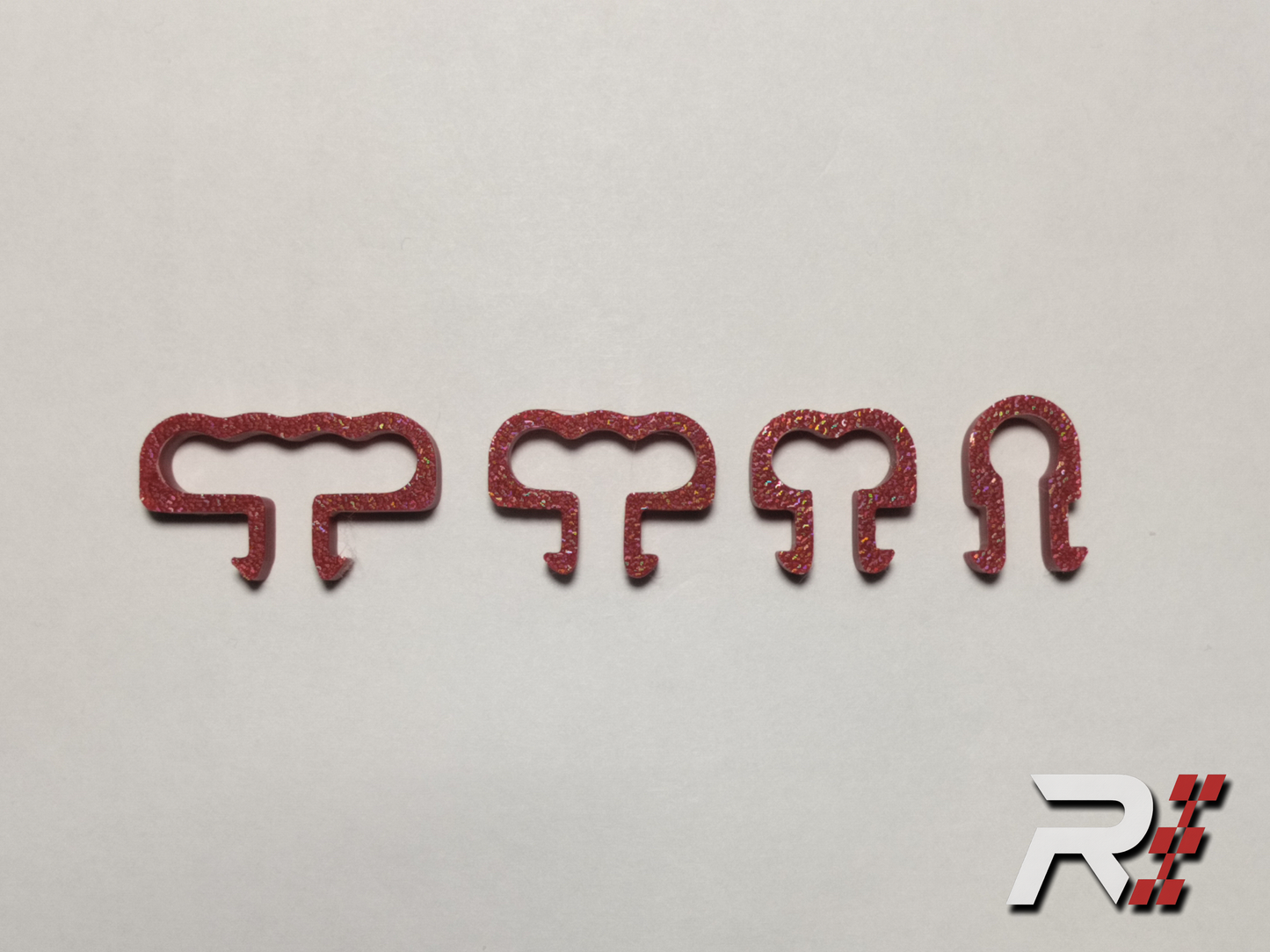 “RaceCraft 3D red snap-fit cable clip set with four different clip sizes displayed for organizing sim rig cables.”